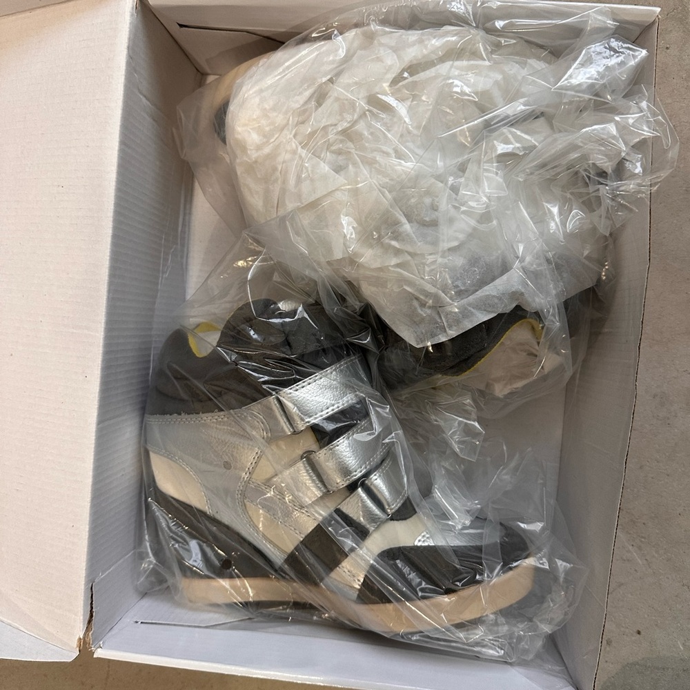 Size 6 wedge sneaker. Never used. Still in the box.